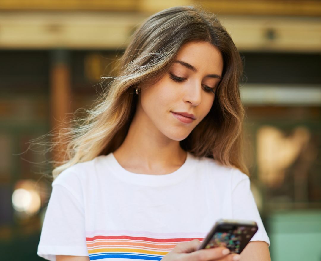Blonde woman looking at her phone