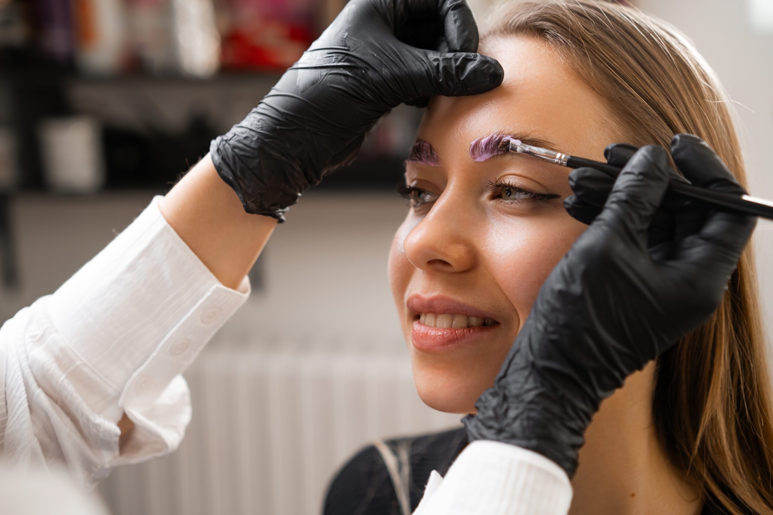 a,woman,receives,a,brow,lamination,procedure,from,a,professional